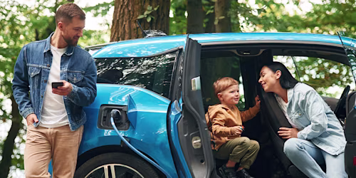 family charging electric car