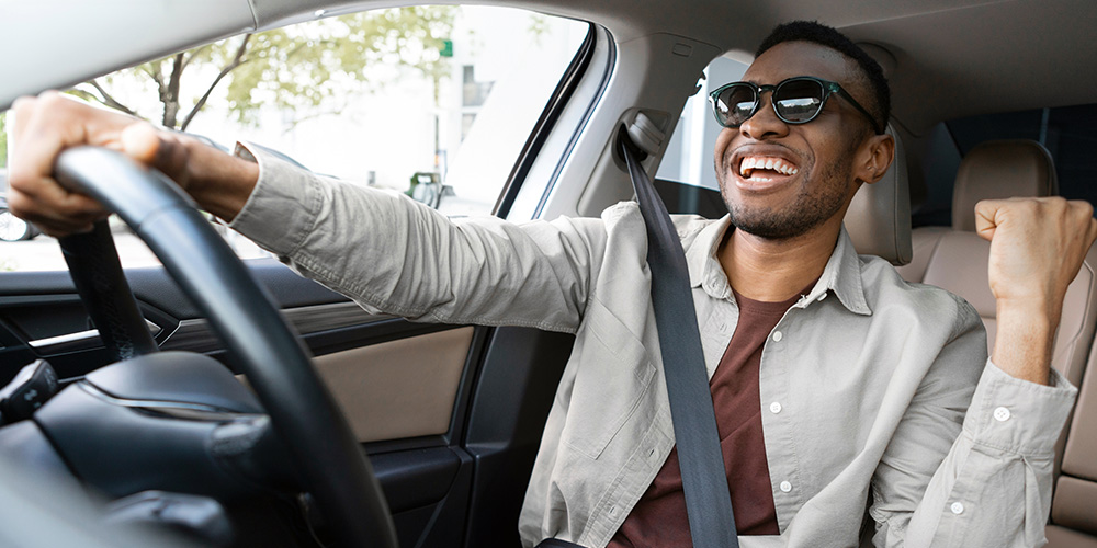 Man dancing and singing while driving