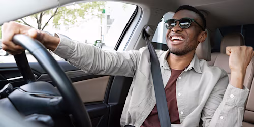 man dancing singing in car