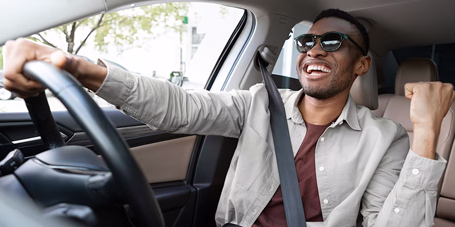 Man dancing and singing while driving