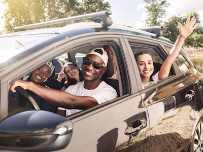 Group of friends driving in car