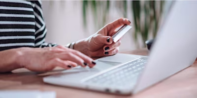 Woman on laptop with MoneySuperMarket logo displayed
