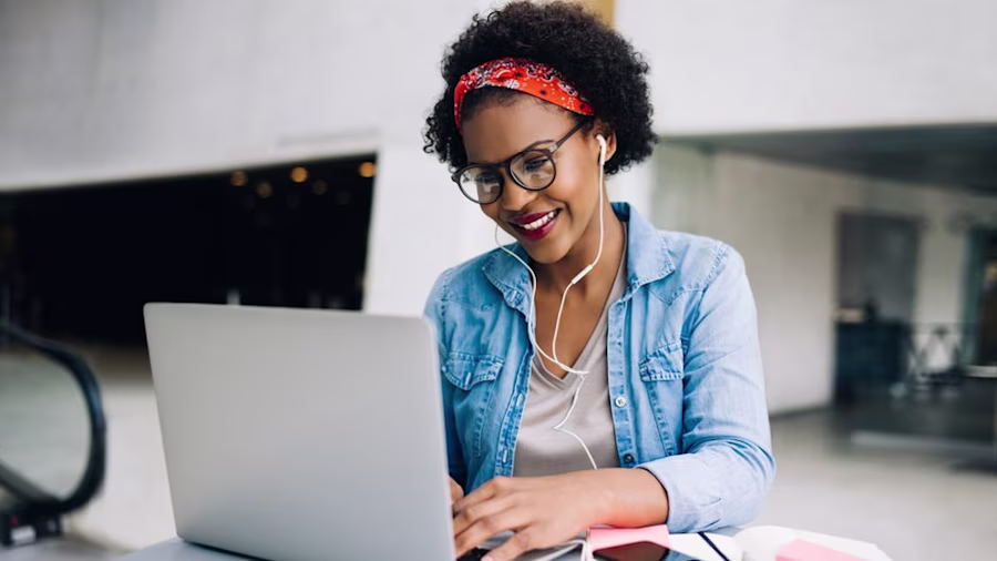 Woman using laptop smiling