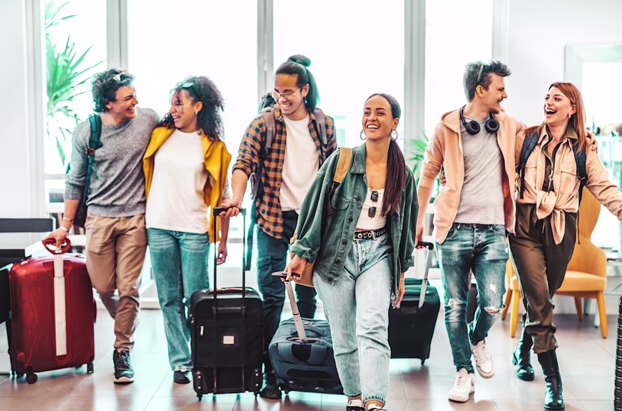 Group of friends with suitcases in airport