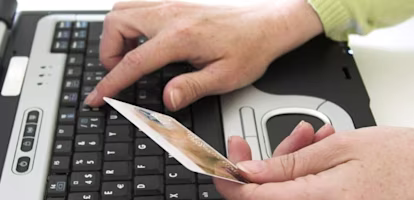 Woman on laptop with MoneySuperMarket logo displayed