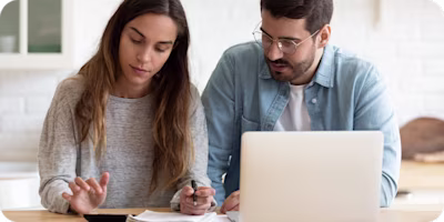 Woman on laptop with MoneySuperMarket logo displayed