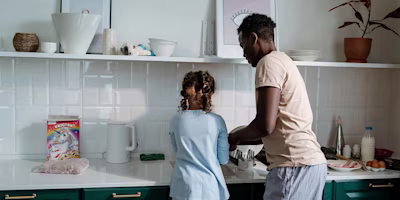 Father and daughter washing dishes together