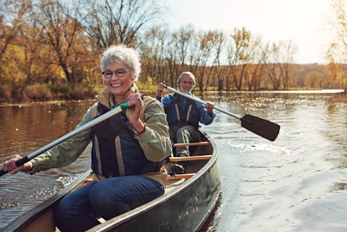 Older couple canoeing on a lake