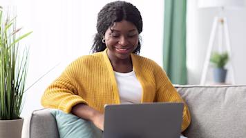 Woman on laptop with MoneySuperMarket logo displayed