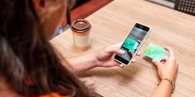 Woman on laptop with MoneySuperMarket logo displayed