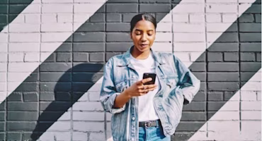 Woman on laptop with MoneySuperMarket logo displayed