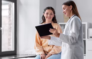 Woman on laptop with MoneySuperMarket logo displayed