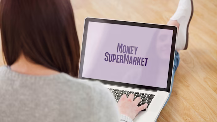 woman with laptop showing MoneySuperMarket on her lap