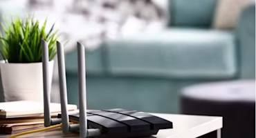 Woman on laptop with MoneySuperMarket logo displayed