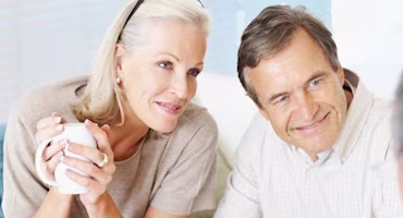 Woman on laptop with MoneySuperMarket logo displayed