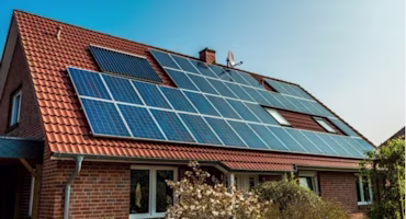 Woman on laptop with MoneySuperMarket logo displayed