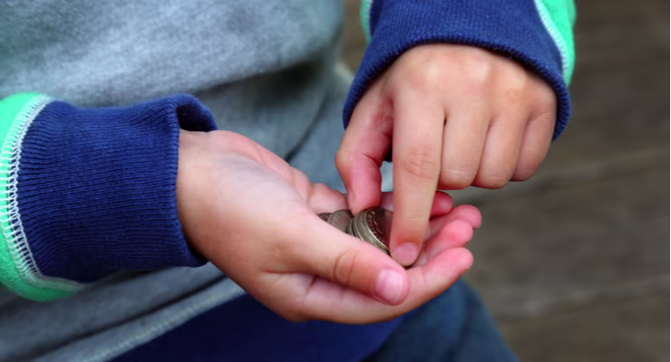 Young boy counting pocket money