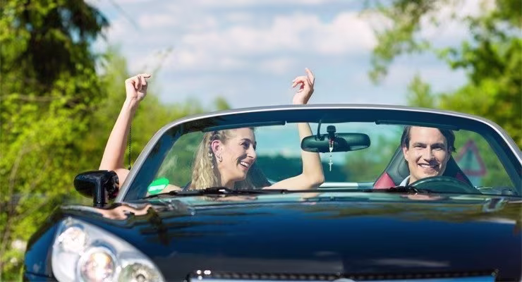 couple in a car smiling 