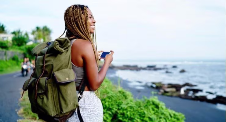 Female backpacker by beach