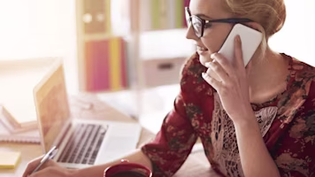 Woman on laptop with MoneySuperMarket logo displayed