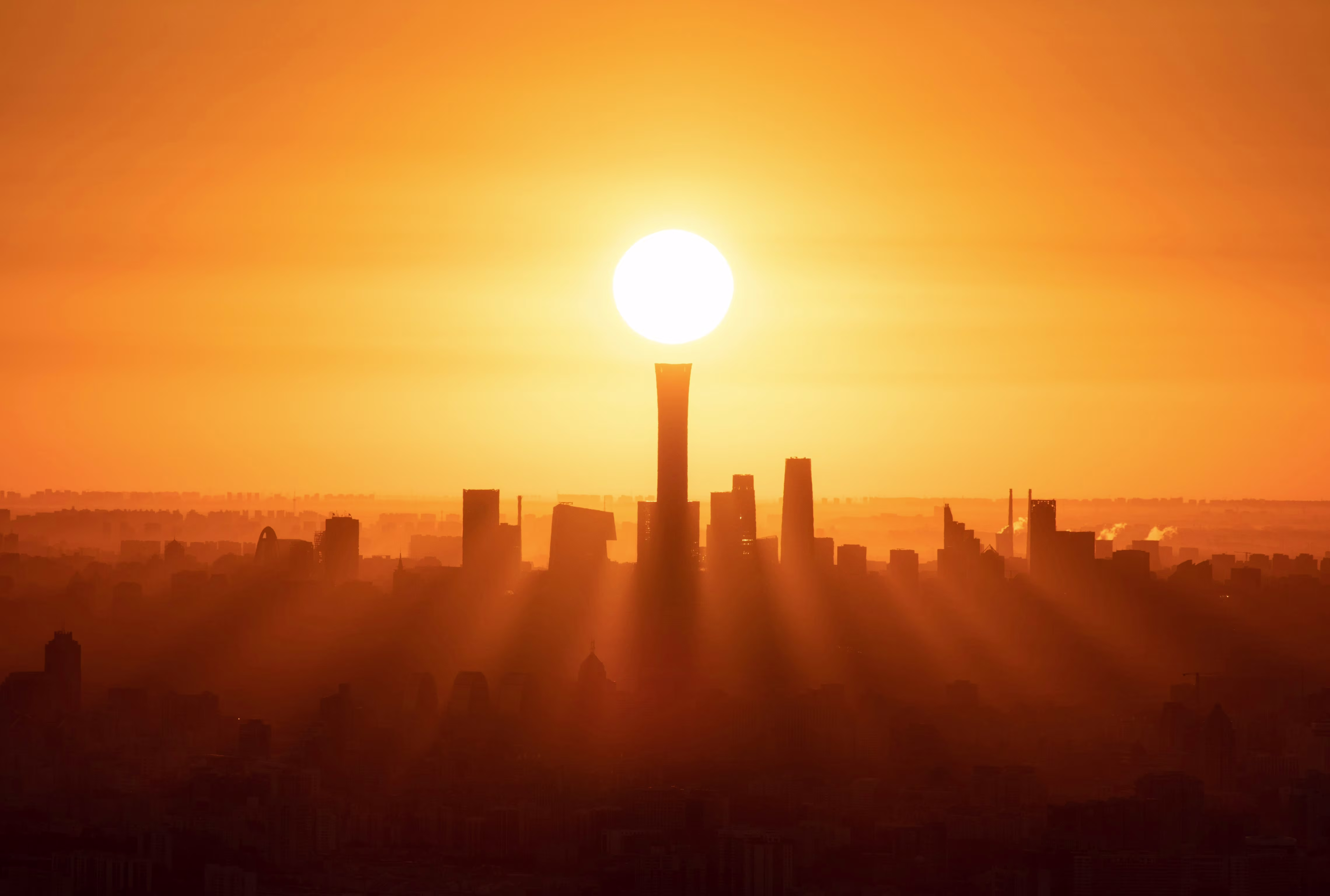 Sun setting over city