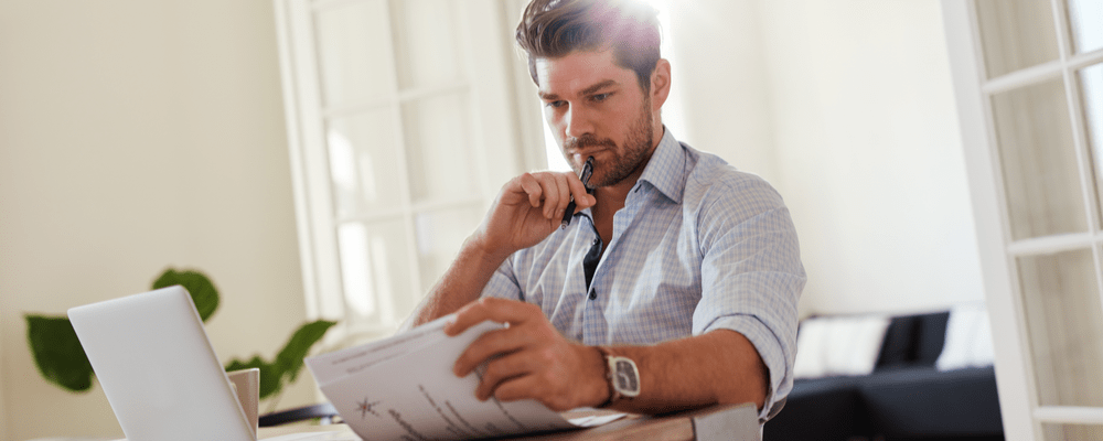 Man with laptop and paperwork