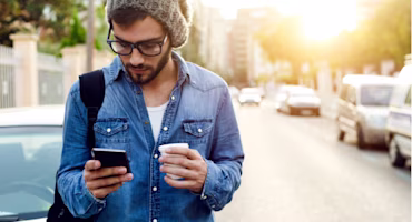 Woman on laptop with MoneySuperMarket logo displayed