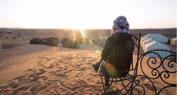 Traveller sitting in the sand