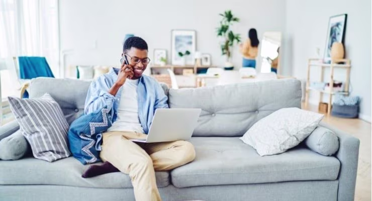man on phone and laptop