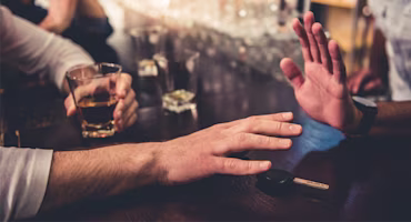 Woman on laptop with MoneySuperMarket logo displayed