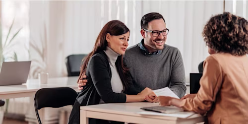 Couple signing mortgage agreement
