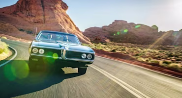 Woman on laptop with MoneySuperMarket logo displayed