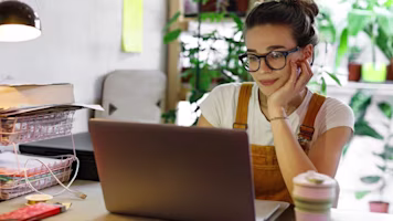 Woman on laptop with MoneySuperMarket logo displayed