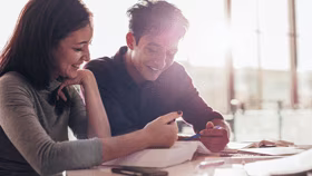 Woman on laptop with MoneySuperMarket logo displayed
