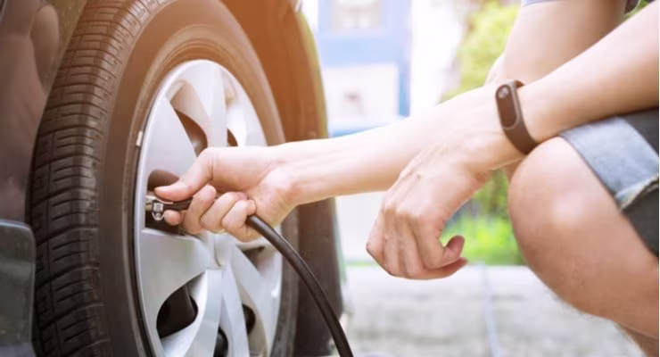Man checking tyre pressure