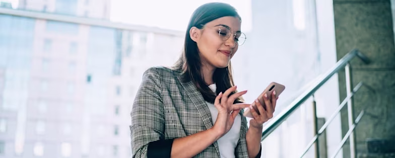 Woman with phone smiling 