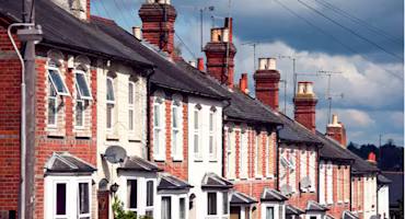 Woman on laptop with MoneySuperMarket logo displayed