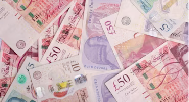 Woman on laptop with MoneySuperMarket logo displayed