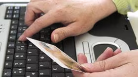 Woman on laptop with MoneySuperMarket logo displayed
