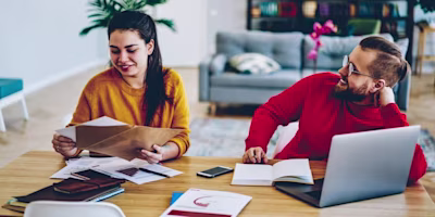 Woman on laptop with MoneySuperMarket logo displayed
