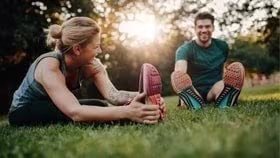 man and women stretching after exercise
