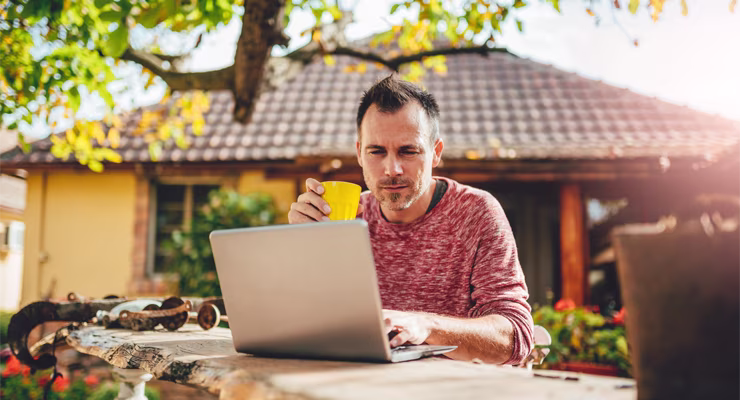 Man using laptop outdoors