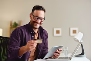 Woman on laptop with MoneySuperMarket logo displayed