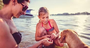 Family on beach with their dog