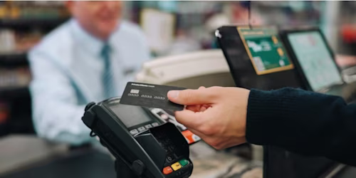 woman paying with prepaid dollar card