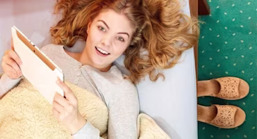 Woman on laptop with MoneySuperMarket logo displayed