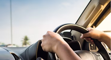 Woman on laptop with MoneySuperMarket logo displayed