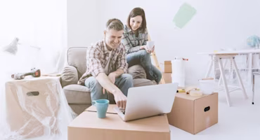 Woman on laptop with MoneySuperMarket logo displayed
