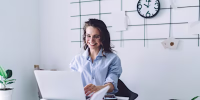 Woman smiling with a laptop