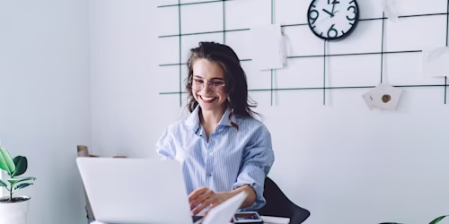 Woman smiling beneath clock